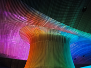 Senedd Funnel lit up in the colours of a rainbow